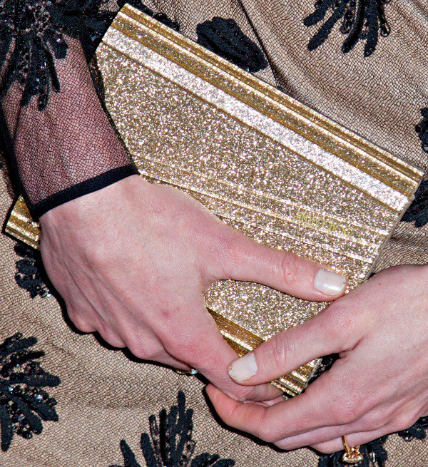 Hilary Rhoda carried a gold clutch from Jimmy Choo