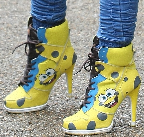 Her bright yellow SpongeBob SquarePants lace-up booties featured cartoon graphics and stiletto heels, bringing a quirky, fun vibe to her street style