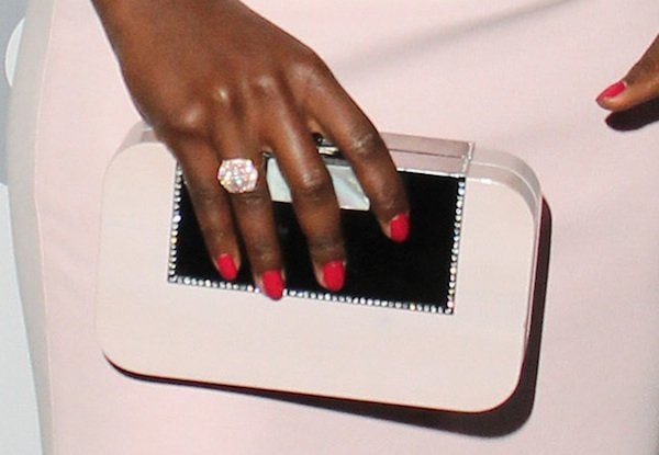 Lupita carried a pale pink wooden clutch from Devi Kroell