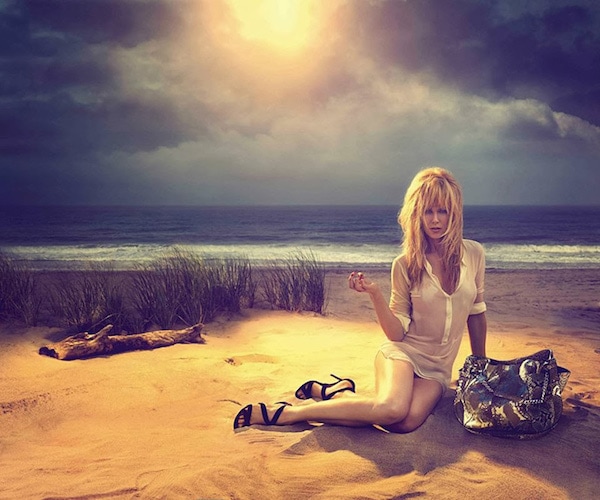 Nicole Kidman lounges on a sun-drenched shoreline in Jimmy Choo’s Cruise 2014 campaign, pairing the brand’s black strappy heels with a metallic python bag for a sultry, beach-glam moment