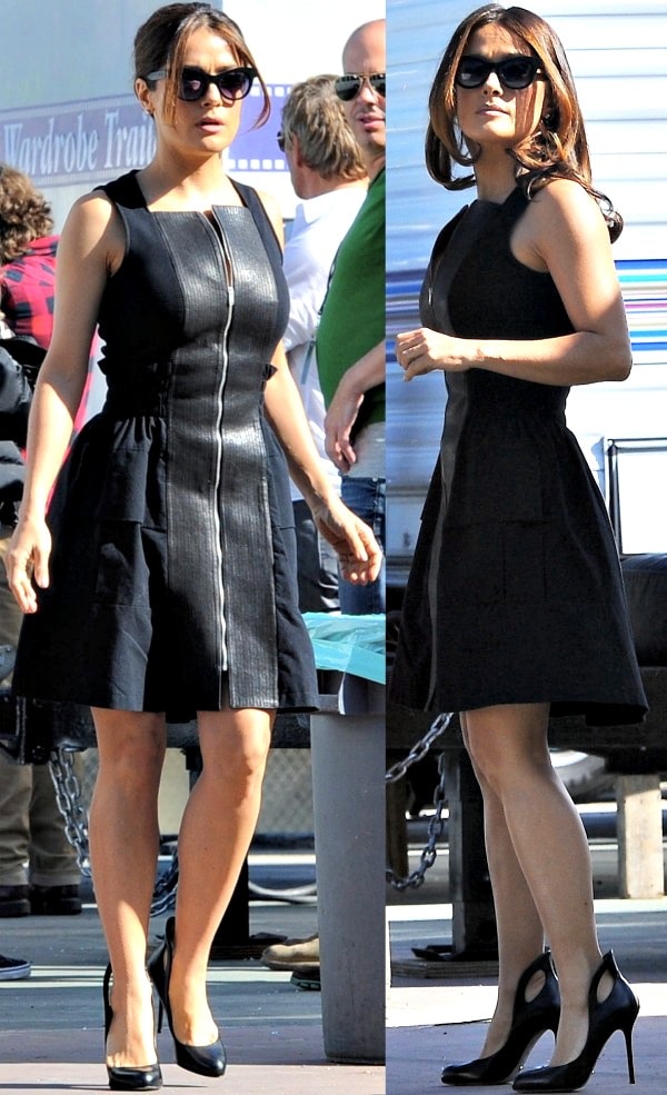 Salma Hayek wears a sleek black dress with a striking zip-front detail, complementing her look with Sergio Rossi's black 'Oblo' pumps
