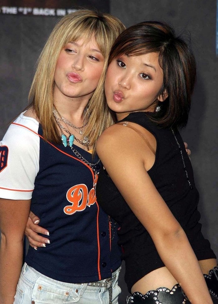 Ashley Tisdale and Brenda Song strike playful poses at the premiere of Mr. 3000 at El Capitan Theater in Los Angeles on September 8, 2004