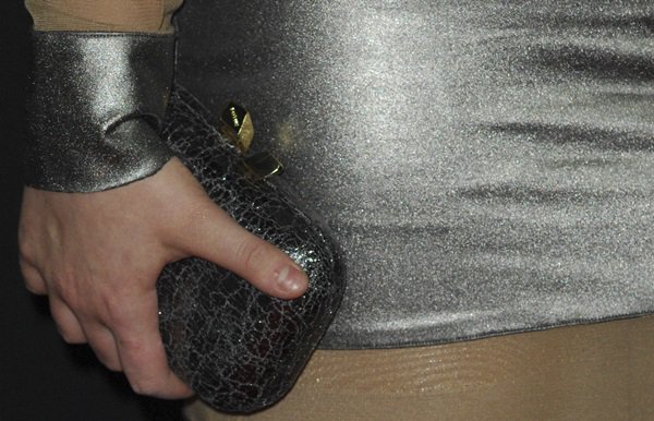 Abigail Breslin accessorizes with a small metallic clutch