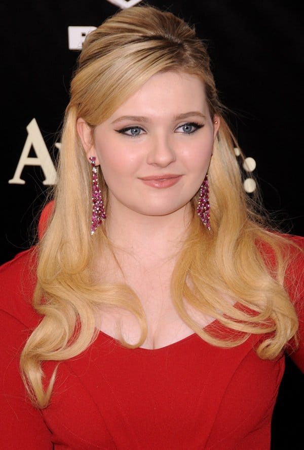 Abigail Breslin completes her look with voluminous waves and sparkling pink earrings