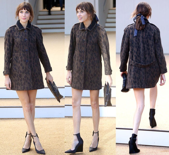 Alexa Chung effortlessly combines sophistication and playfulness with an animal-print coat, sleek black ankle-strap wedges, and a chic ribbon-tied ponytail