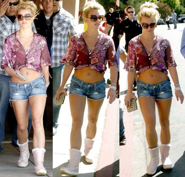 Britney Spears kept it casual and trendy while leaving Target in Los Angeles on September 30, 2009, pairing pink UGG boots with cutoff denim shorts and a sheer floral crop top for a laid-back, summer-inspired look