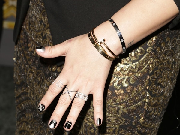 Demi Lovato showcases her Cartier Love bracelet, statement rings, and edgy nail art at The X Factor Season 3 Finale in Los Angeles on December 20, 2013