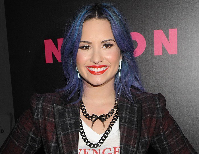 Demi Lovato with red lipstick and blue hair at the Nylon December issue party