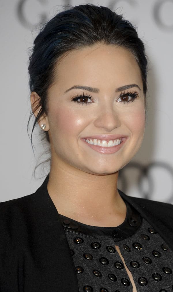 Demi Lovato's radiant smile, flawless makeup, and perfectly defined eyes shine at The Hollywood Reporter's Women in Entertainment Breakfast
