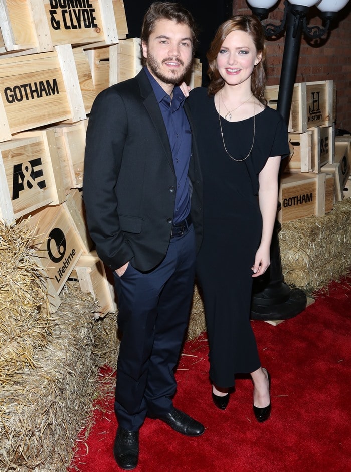 Posing with Emile Hirsch, Holliday Grainger elevates her sleek black column dress with glossy black platform pumps, using added height to elongate her petite 5ft 2¼ frame on the red carpet