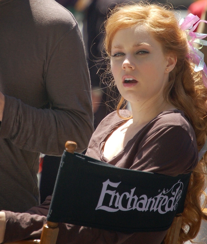 Amy Adams takes a break on the set of Enchanted, sitting in her director's chair while preparing for her role as Giselle