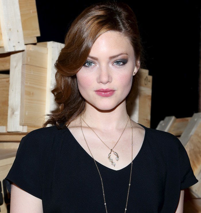 Holliday Grainger wears her red hair down and curled at the Bonnie Clyde premiere party