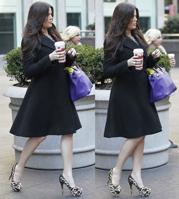 Khloé Kardashian keeps her black coat understated while leopard-print platform pumps and a vivid purple handbag bring pattern and color to the look