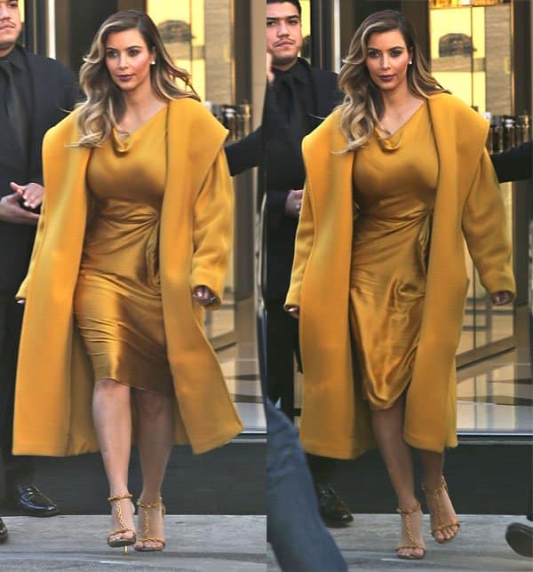 Kim Kardashian attended the Hollywood Reporter's Women in Entertainment Breakfast on December 11, 2013, wearing a Lanvin boat neck fitted dress, Max Mara teddy yellow coat, Tom Ford Spring 2012 sandals, and a Bottega Veneta gold metal mesh intrecciato knot clutch