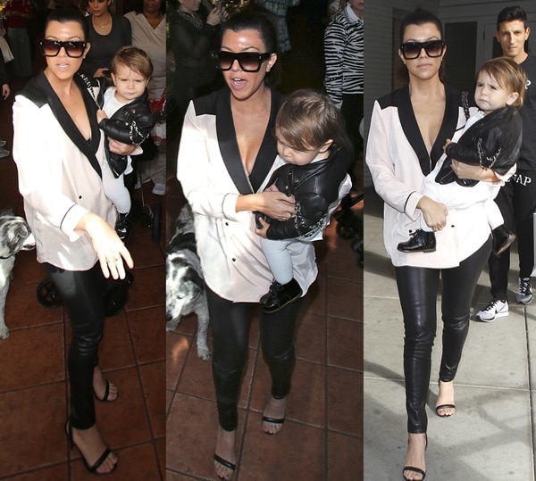 Carrying daughter Penelope, Kourtney Kardashian styled an Asos color-block tuxedo blouse with Alice + Olivia faux-leather leggings and minimalist Alexander Wang “Antonia” sandals, accessorized with Dita oversized sunglasses and a Chanel CC lambskin backpack