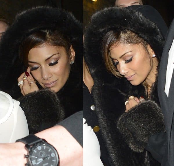 Nicole Scherzinger keeps her glam intact with soft smoky eyes, glossy nude lips, and side-swept hair peeking from her hood—finished with diamond stud earrings and a bold red manicure for understated elegance