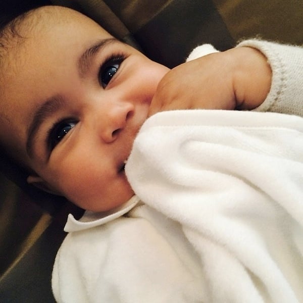 North West, daughter of Kim Kardashian and Kanye West, adorably cuddles her blanket in this precious snapshot