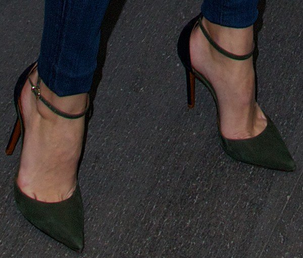 The Schutz Irma d’Orsay pumps reveal their two-tone design, slim ankle strap, and sleek pointed-toe silhouette