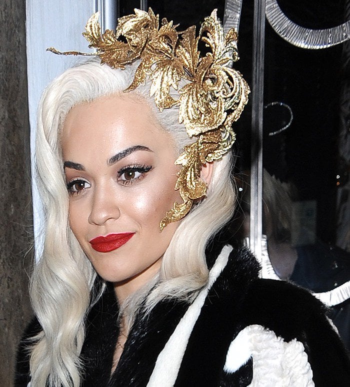 Rita Ora crowns her platinum waves with a sculptural gold leaf headpiece by Philip Treacy