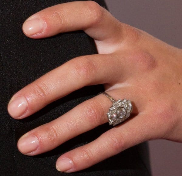 Scarlett Johansson's unique art deco engagement ring, adorned with three vertically set diamonds and surrounded by intricate detailing, captures a perfect blend of vintage charm and modern elegance