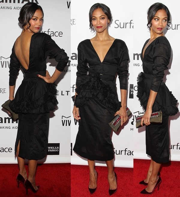 Zoe Saldaña captivates in a black-belted peplum dress by Marni, styled with Christian Louboutin "Pigalle" pumps, showcasing a deep V-neckline and asymmetrical ruffles