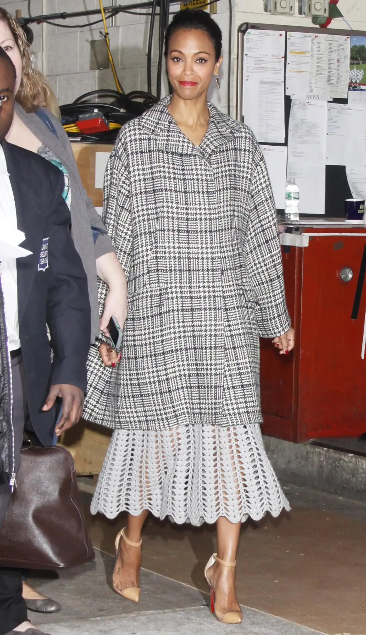Zoe Saldaña exits ABC studios in New York City wearing Melinda Maria earrings and a Dolce Gabbana coat after promoting her new movie, "Out of the Furnace," on Live! with Kelly Michael on December 5, 2013