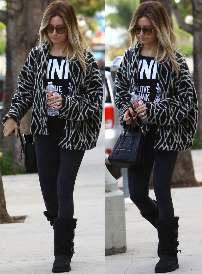 Ashley Tisdale stepped out in Studio City, California, on December 14, 2014, looking effortlessly cool in black UGG Bailey Button Triplet boots, skinny jeans, a graphic tee, and a cozy patterned cardigan, completing her look with oversized sunglasses and a black leather handbag.