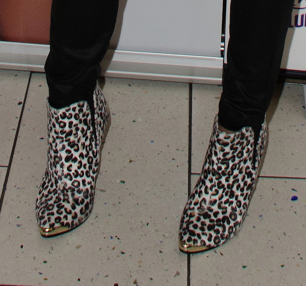 Chloe Sims adds a bold touch to her look with these eye-catching leopard-print ankle boots featuring metallic toe caps