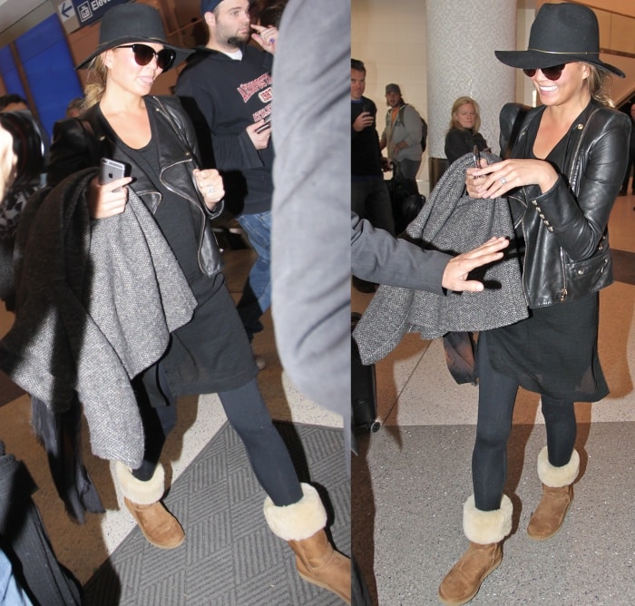 Chrissy Teigen was spotted arriving at Los Angeles International Airport on January 23, 2015, exuding airport chic in a black leather jacket, matching black ensemble, leggings, tan UGG boots with a cozy fur trim, oversized sunglasses, and a stylish black hat