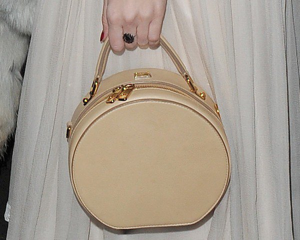 Daisy Lowe toting a circular handbag