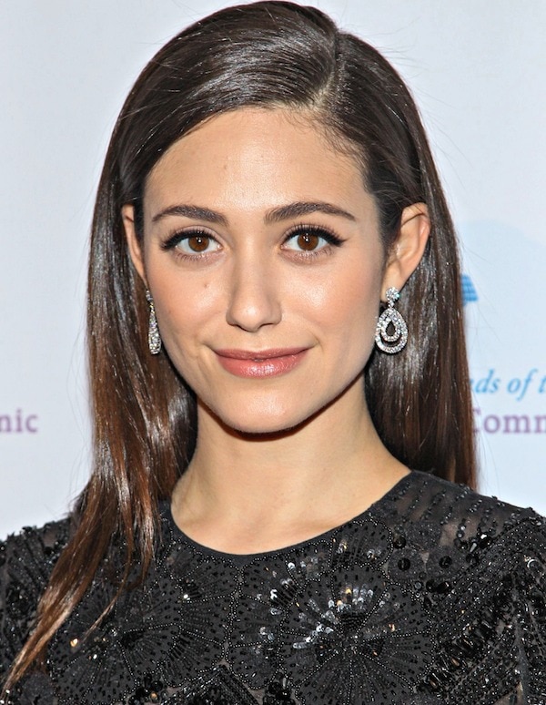 Emmy Rossum keeps her beauty look understated with sleek side-parted hair and Chopard diamond drop earrings that mirror the shimmer of her embellished Naeem Khan ensemble