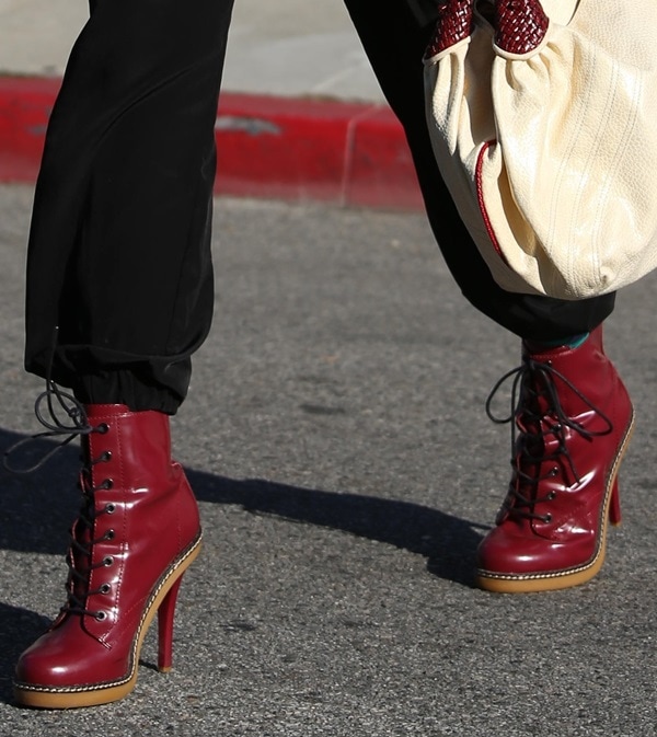Gwen Stefani transformed the L.A.M.B. Nichol booties into the centerpiece of her outfit by choosing a glossy red leather version that echoed her signature red lipstick and added a bold pop of color to her monochrome look