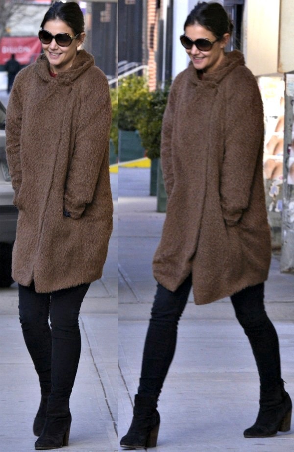 Katie Holmes bundled up in a cozy brown coat, pairing it with dark skinny jeans and black suede Rag Bone 'Newbury' ankle boots for a chic winter street style in Manhattan