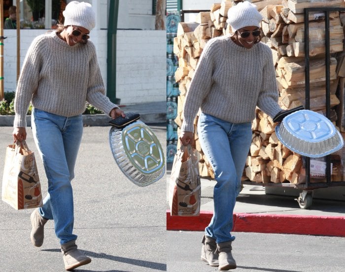 Kelly Rowland was seen at Bristol Farms in Beverly Hills, California, on November 26, 2015, looking effortlessly casual in a cozy ribbed sweater, light-wash jeans, gray UGG boots, and a white beanie, perfect for a day of Thanksgiving preparations