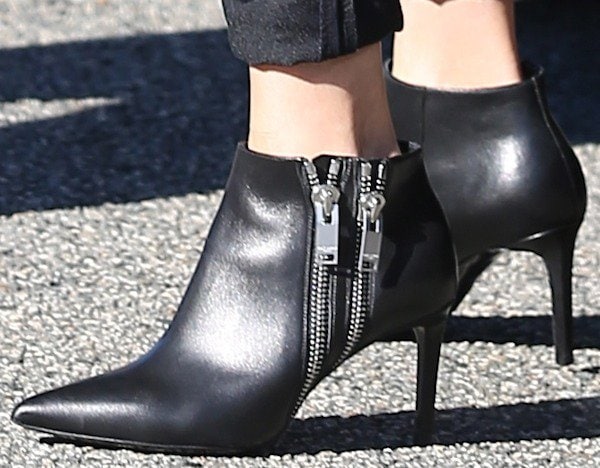 Reese Witherspoon completed her look with sleek Saint Laurent double zipper booties