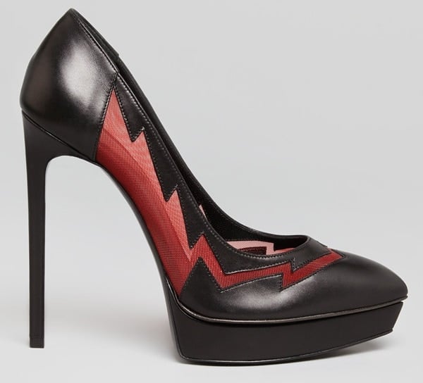 The red-mesh Lightning Bolt pumps showcase Saint Laurent's glam-rock aesthetic, pairing a dramatic stiletto platform with a bold crimson zigzag motif that draws the eye from heel to toe