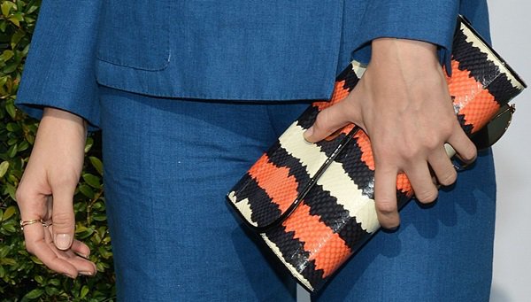 Caitlin Fitzgerald toting a multicolor clutch by Christian Louboutin