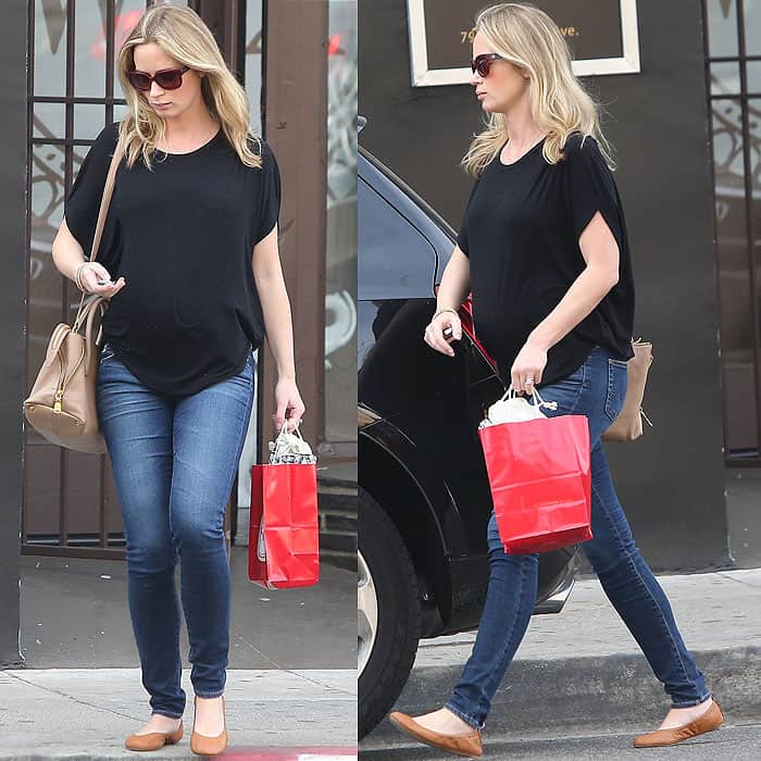 Emily Blunt keeps her maternity style effortlessly relaxed in skinny jeans and a loose black tee, finishing the casual Los Angeles shopping look with tan ballet flats and oversized sunglasses