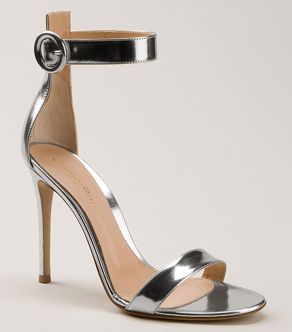 A sleek metallic Gianvito Rossi stiletto sandal featuring a minimalist toe strap, high mirrored heel, and adjustable ankle buckle, designed to elongate the leg while delivering a polished, evening-ready finish