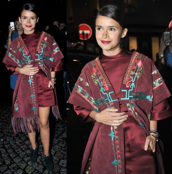 Miroslava Duma turns heads in a burgundy Valentino dress with intricate hand-stitch detailing at the Valentino Spring/Summer 2014 Show during Paris Fashion Week on January 22, 2014