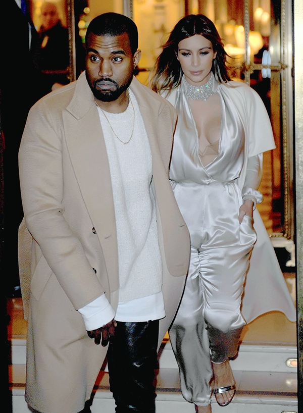 Kim Kardashian, in a plunging satin jumpsuit with metallic sandals, steps out with Kanye West, who pairs a camel coat with leather pants