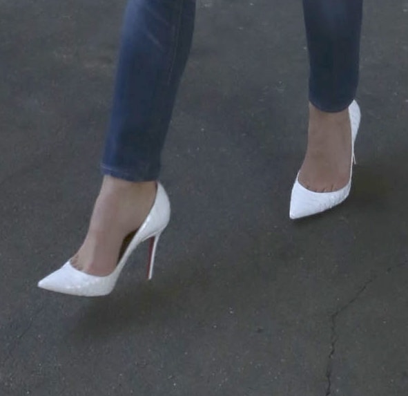 A closer look at Keri Russell's white python-print Christian Louboutin "Batignolles" pumps, featuring a sharply pointed toe and slender stiletto heel that added polish to her casual airport outfit