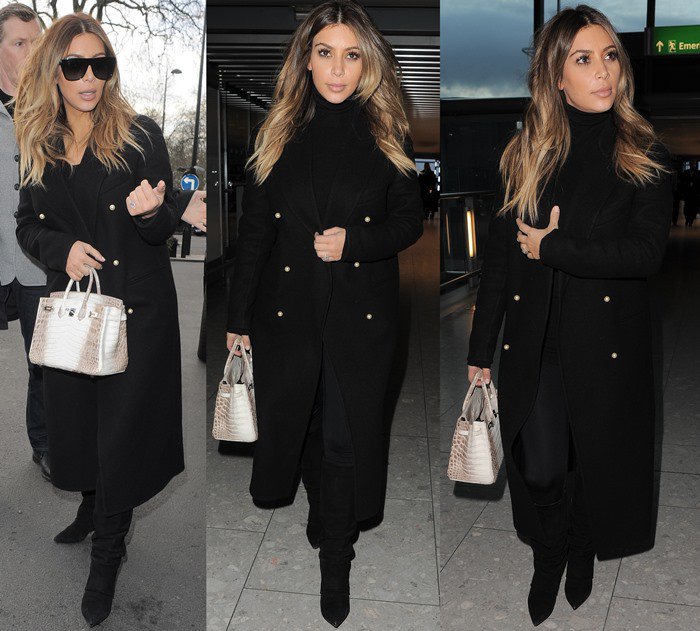 Kim Kardashian bundles up in a sleek black double-breasted coat and suede knee-high boots, accessorizing with a rare and ultra-luxurious Hermès Himalayan Birkin bag as she arrives at Heathrow Airport