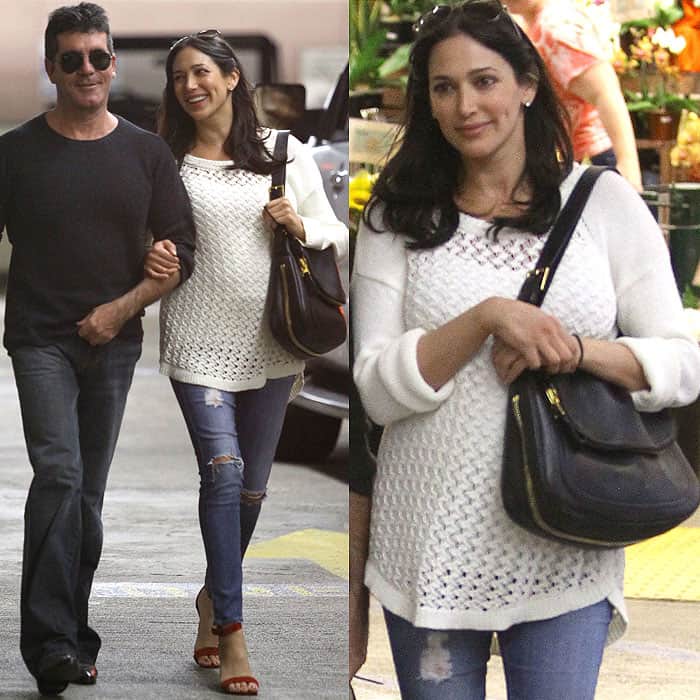 Lauren Silverman steps out in Beverly Hills with Simon Cowell, pairing distressed skinny maternity jeans and a loose knit sweater with red ankle-strap sandals for a relaxed yet polished pregnancy look