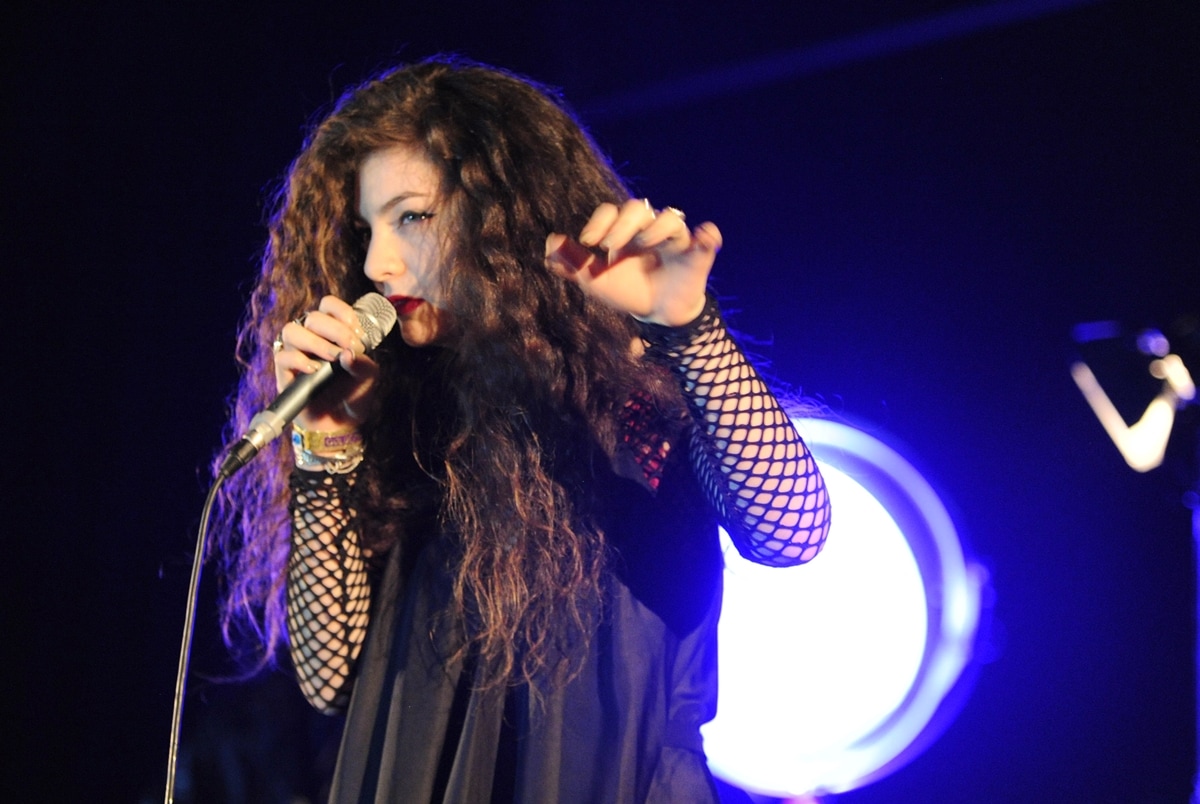 Lorde captivates the audience with her intense performance and signature dark aesthetic during a live show