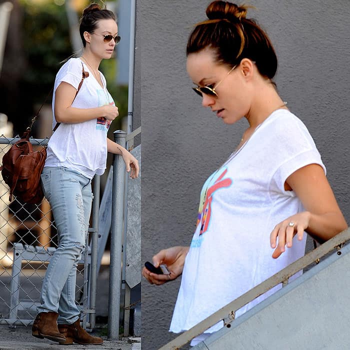 Olivia Wilde flaunts her baby bump in a vintage MTV T-shirt and skinny jeans during a casual outing