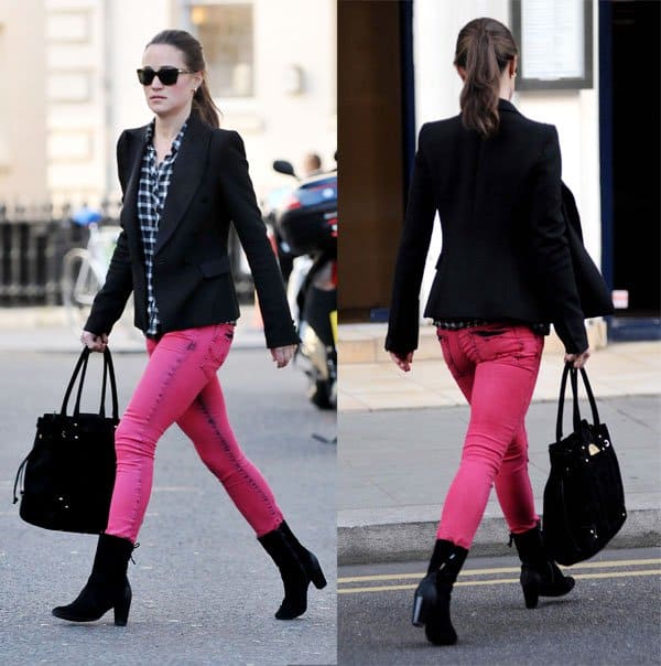 Pippa Middleton walking in hot pink skinny jeans, a black blazer, a checkered shirt, and black suede boots while carrying a black handbag in London
