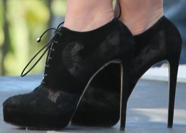 Sophia Bush flaunts her black lace Bionda Castana Karlie booties, featuring a delicate pattern and a sleek high heel