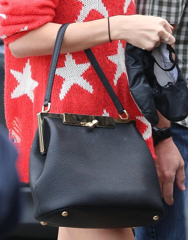 Taylor Swift carrying a Dolce Gabbana "Sara" shoulder bag, showcasing her love for classy purses