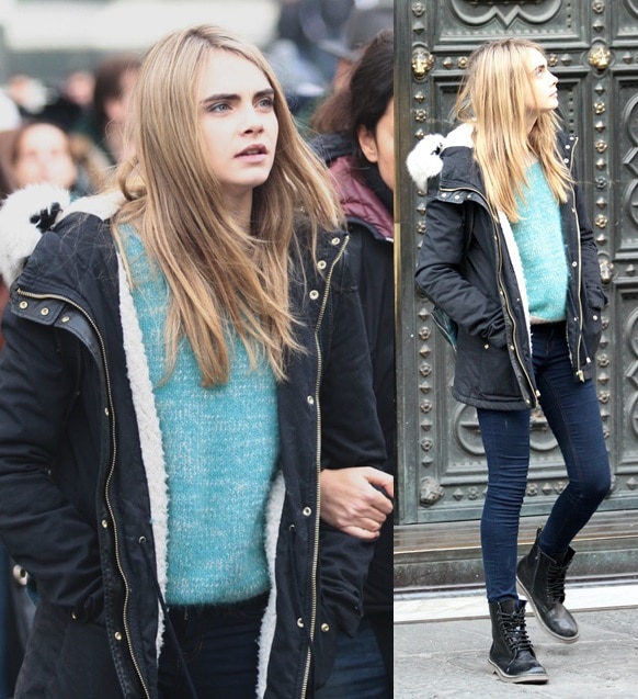 Cara Delevingne keeps it casual-chic in lace-up combat boots, skinny jeans, and a teal sweater layered under a sherpa-lined parka while filming The Face of an Angel in Florence